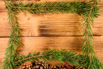 Frame of the fir tree branches on a wooden table