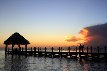 Family enjoying sunset on vacation.