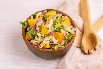 Tasty salad with frisee, persimmon, grilled chicken fillet and sesame