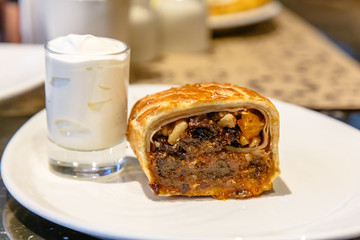 Strudel with prunes, dried apricots and nuts lying on a plate.