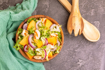 Tasty salad with frisee, persimmon, grilled chicken fillet and sesame