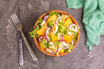 Tasty salad with frisee, persimmon, grilled chicken fillet and sesame