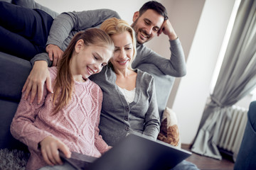 Young family watching movie on the laptop