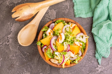 Tasty salad with frisee, persimmon, grilled chicken fillet and sesame