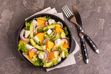 Delicious salad with frisee, persimmon, feta, chicken fillet and onion