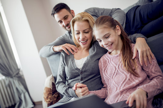 Young family watching movie on laptop