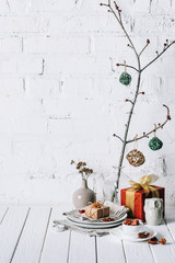 Christmas decoration with gifts on white rustic table