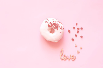 White glazed donut  with black chocolate sweets on colar background. Flat lay. Food concept, colorful breakfast. Color of 2019. 