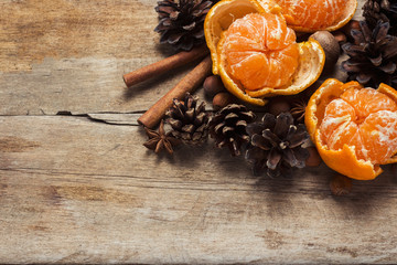 Tangerines, cones, spices on a wooden background. Сoncept of New Year and Christmas, Christmas drink Mulled wine. Flat lay, top view