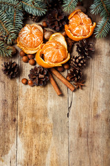 Tangerines, Christmas tree branches, cones, spices on a wooden background. Сoncept of New Year and Christmas, Christmas drink Mulled wine