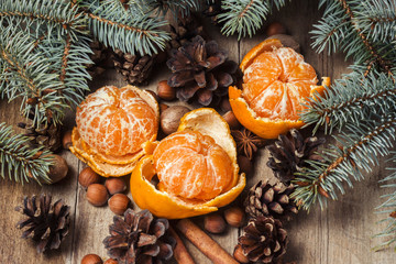 Tangerines, Christmas tree branches, cones, spices on a wooden background. Сoncept of New Year and Christmas, Christmas drink Mulled wine