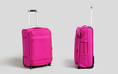 Pink luggage trolley suitcase side and front view isolated on gray background