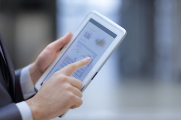 close up.businessman working on a digital tablet with financial