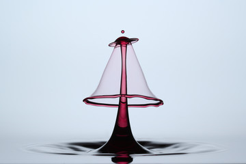 red abstract waterdrop sculpture formed after collision