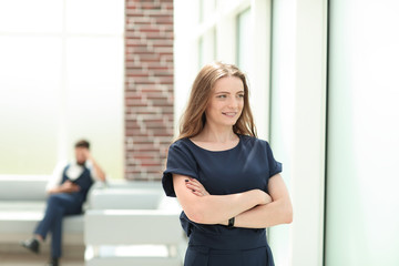 confident young businesswoman standing near the office window.