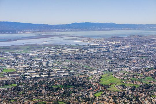 Aerial view of Fremont and Newark on the shoreline of east San Francisco bay area; Dumbarton bridge in the background; Silicon Valley, California