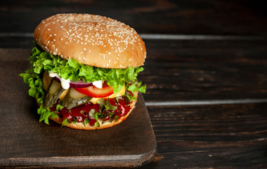 mouth-watering delicious homemade burger used to chop beef on the wooden table