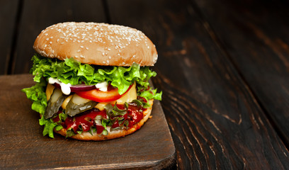 mouth-watering delicious homemade burger used to chop beef on the wooden table