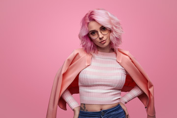 Confident hipster woman in pink jacket