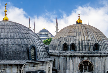 Fototapeta na wymiar Domes of Saint Sophie Cathedral and Blue Mosque, from Saint Sophie - Istanbul, Turkey