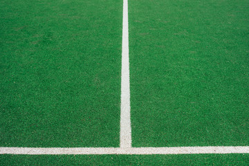 Obraz premium White lines on green soccer or football field. Perpendicular lining.
