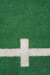 White marks and lines on green soccer or football field.  Copy space. Top view.