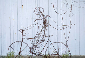 Installation of biker on the background of white wall