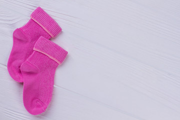 Pink socks on wood.