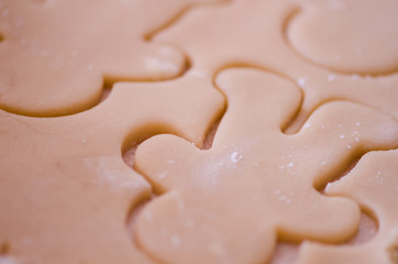 Abstract selective focus macro view of sugar cookie Christmas dough cut out with a gingerbread cookie cutter. Useful for abstract backgrounds
