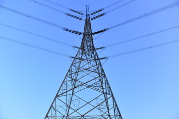 The silhouette of the evening electricity transmission pylon