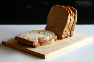 Slice white breads on the wooden board.