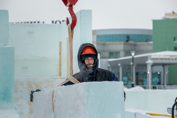 Portrait of an assembler in an orange helmet
