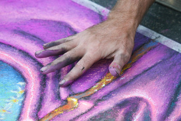 Hand painting abstract chalk art on the streets of San Diego California