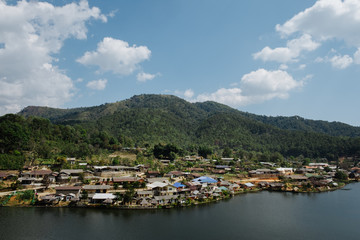 home town in the River with blue cloudy sky, Riverside view at Rak Thai Village, Mae hong son, Thailand