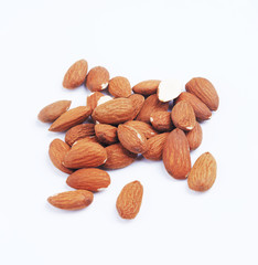 Almond isolated. Group of nuts on white background. Pile of almonds seeds collection. Shallow depth of field. Flat lay, top view.