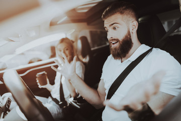 Man Is Driving A Tesla Car. Girl At Front Seat.