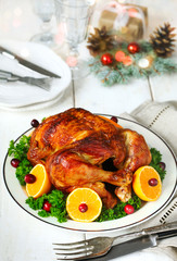 Roasted chicken served with citrus and cranberry on plate