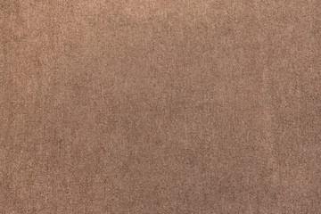 Brown carpet fabric flooring pattern surface texture. Close-up of interior material for design...