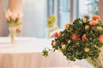 Bouquet of white flowers in a vase, candles. wedding home decor on a table