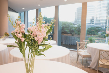 Bouquet of white flowers in a vase, candles. wedding home decor on a table