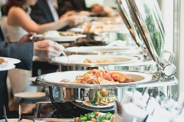 people group catering buffet food indoor in luxury restaurant with meat colorful fruits and...
