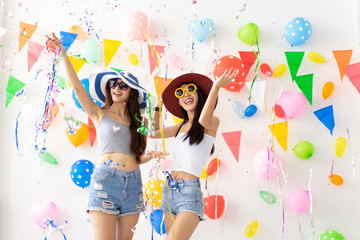 Obraz na płótnie Canvas celebration new year or birthday party group of asian young woman and confetti happy,funny concept.drinking wine happy and fun in new year celebrate, color balloon background.