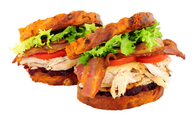 Chicken and bacon toasted sandwiches with cranberry jam isolated on a white background