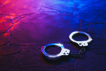 handcuffs on the floor at night