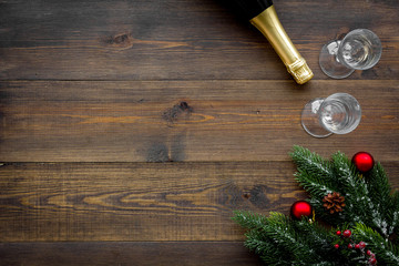spruce, champagne bottle and glasses for christmas celebration on wooden background top view mockup