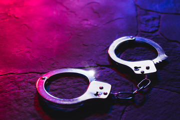 handcuffs on the floor at night