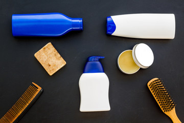 shampoo bottle and comb for man care in barbershop dark background top view mockup