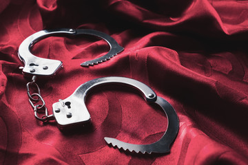 Kinky handcuffs on the bed sheets