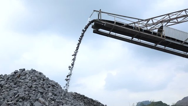 Slow motion shot of quarry mine industry rock extraction heavy machinery equipment