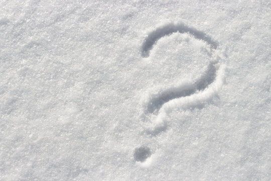 Question mark on white snow, close up, copy space